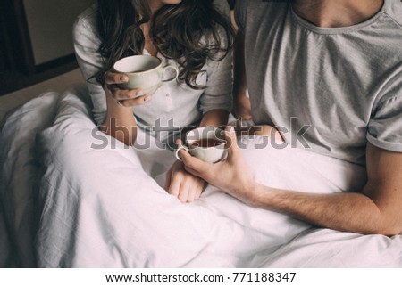 lovers holding together a Cup of tea