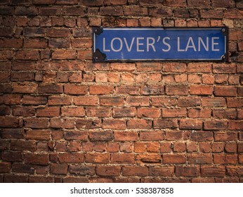 Lover's Lane Sign On A Grungy Old Red Brick Wall