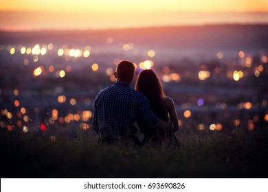 Lovers man and girl against background night city, night starry sky and horizon. Concept date Valentine's Day, first kiss love, forever together.