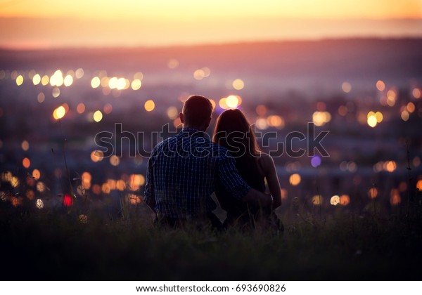 Lovers man and girl against background night\
city, night starry sky and horizon. Concept date Valentine\'s Day,\
first kiss love, forever\
together.