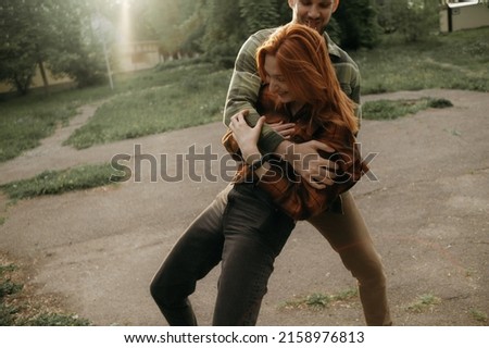 Similar – Joyful couple laughing together on a vintage sofa