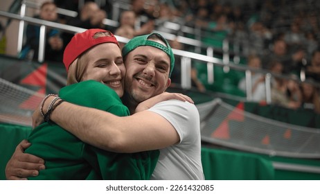 Loves couple date sport stadium. Romantic lovers hug. Fan look camera together. Smile girl play bet. Nice guy joy romance. Happy love relationship. Fun man win goal. Cute couples watch match close up. - Powered by Shutterstock