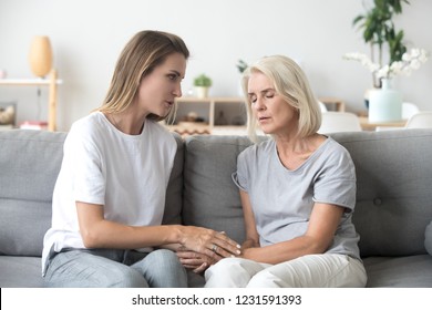 Loving Adult Daughter Talking To Sad Old Mother Holding Hand Comforting Upset Older Woman Having Problem, Young Caregiver Helping Senior Patient, Support, Empathy And Care To Elderly Parent Concept