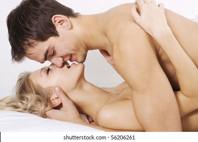 Loving Affectionate Nude Heterosexual Couple On Bed.