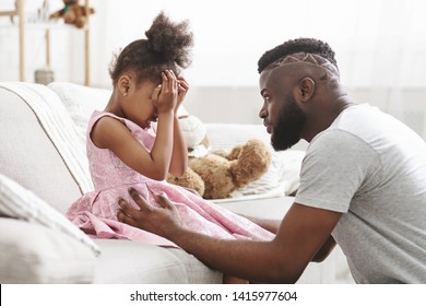 Loving african american dad comforting crying daughter, supporting little stressed girl in tears, giving empathy protection at home