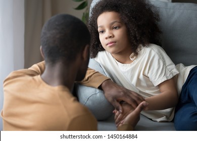 Loving african American dad kneel near upset preschool daughter talk caress her holding hand, caring black father speak with sad girl child comfort and stroke showing support and understanding - Powered by Shutterstock