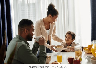 A loving African American family enjoying a meal together at a table. - Powered by Shutterstock