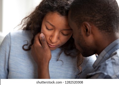 Loving African American Husband Apologizing Comforting Sad Wife, Caring Man Consoling Gently Touching Face Of Upset Woman, Compassion, Empathy And Support In Black Couple Relationships Concept