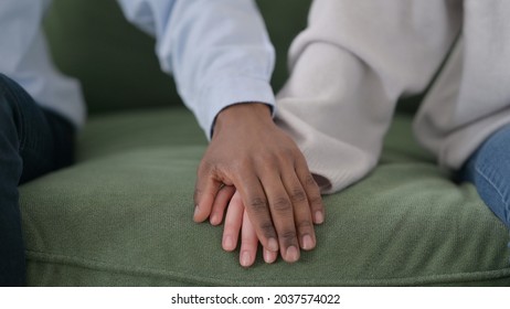 Loving African Man Putting Hand over Caucasian Woman's Hand