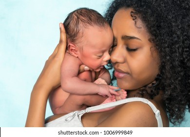 Loving african mother holding her 11 days old newborn baby