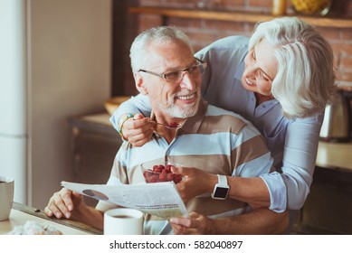Loving aged couple enjoying their breakfast