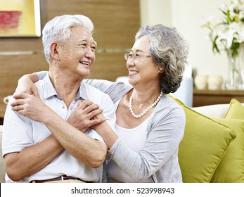 Loving Asian Couple Looking At Each Other Smiling With Appreciation