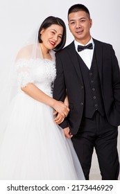 Loving Asian Couple Taking Wedding Photo Together