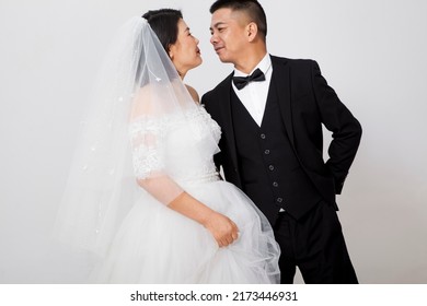 Loving Asian Couple Taking Wedding Photo Together