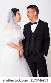 Loving Asian Couple Taking Wedding Photo Together