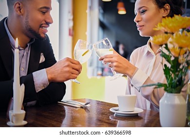 Loving Black American Couple On A Date Drinking Wine In A Restaurant.