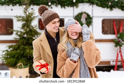 Loving Boyfriend Surprising His Girlfriend With Present During Winter Date On Snowy Day, Covering Her Eyes With Hand And Holding Gift Box, Making Pleasant Christmas, Valentine Or Anniversary Surprise - Powered by Shutterstock