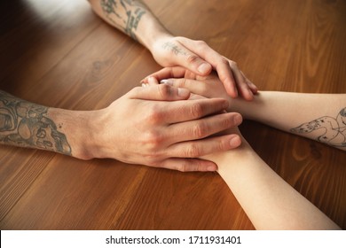 Loving caucasian couple holding hands close-up on wooden background. Romantic, love, relation, tender touching. Supporting and helping hand, family, warm. Togetherness, feeling and emotions. - Shutterstock ID 1711931401