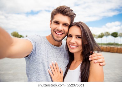 Loving cheerful happy couple taking selfie in the city - Powered by Shutterstock