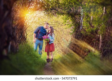 Loving couple in the birch forest. Man and woman walking on nature. Hugging each other. Be happy. Active lifestyle. Summer forest. Warm sunset light.