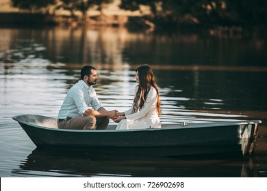 Loving Couple In A Boat On The Lake