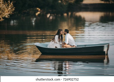 Loving Couple In A Boat On The Lake