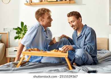 A loving couple cherishes their morning routine with coffee and pastries while cuddling in their pajamas. - Powered by Shutterstock