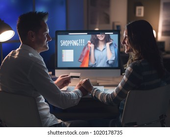 Loving Couple Connecting With A Computer And Doing Online Shopping Late At Night, Relationships And Leisure Concept