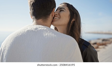 A loving couple embraces on a sunny beach promenade, symbolizing romantic relationship and outdoor togetherness. - Powered by Shutterstock