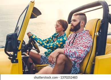 A loving couple in fashionable clothes travel around the paradise exotic islands in a yellow jeep on the beaches and off-road, the real active crazy travelers, a bearded guy and a cheap girl, USA,Bali - Powered by Shutterstock