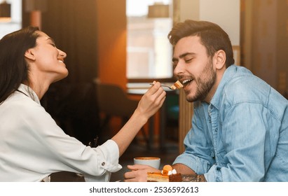 Loving Couple Feeding Each Other Tasting Dessert And Coffee On Romantic Date Sitting In Cafe. Dating And Relationship - Powered by Shutterstock