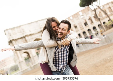 Loving Couple In Front Of The Colosseum In Rome