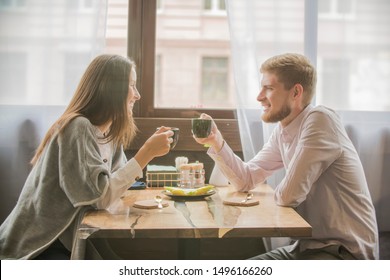 Loving Couple Guy And Girl On A Date In A Cafe