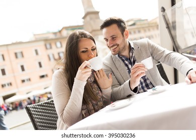 Loving Couple Having A Cup Of Coffee In A Cafe In Rome