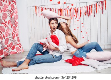 Loving Couple Having A Pillow Fight