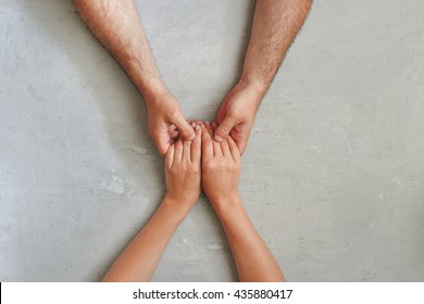 loving couple holding hands sitting at a light table, top view - Powered by Shutterstock