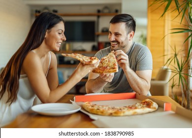 Loving couple at home eating pizza for breakfast, portrait. - Powered by Shutterstock