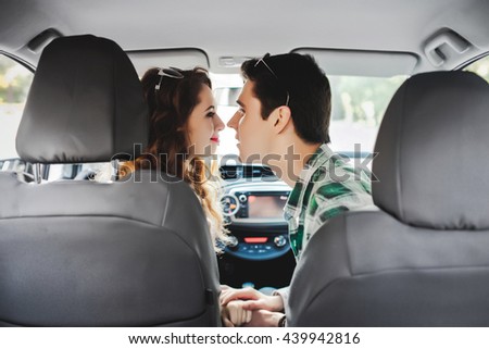 loving couple kissing in the car