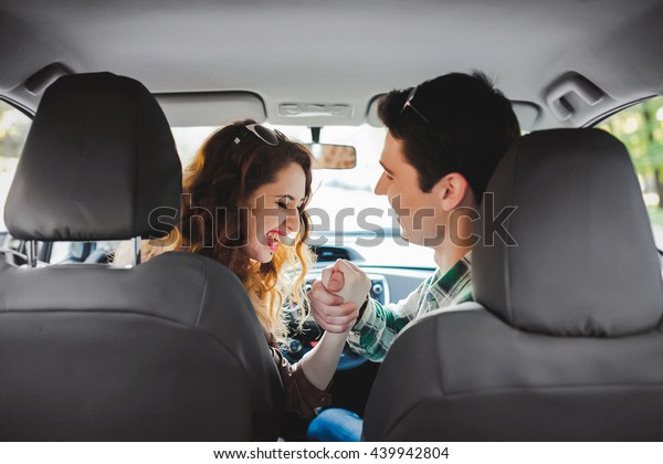 loving couple kissing in the\
car