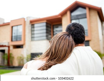 Loving couple looking at their dream house