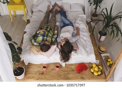 A loving couple is lying on the bed. - Powered by Shutterstock