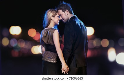 Loving Couple On The Night City Background