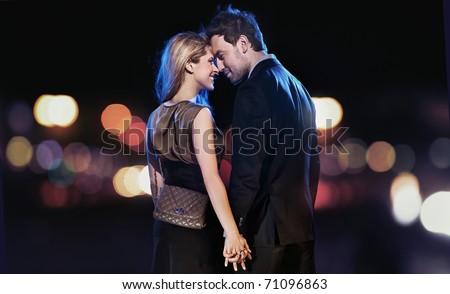 Loving couple on the night city background