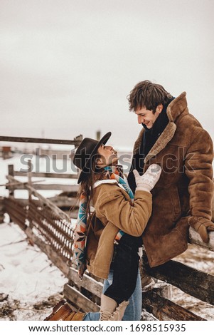 Loving couple on a ranch in the west in winter, NOISE EFFECT ON PHOTOS