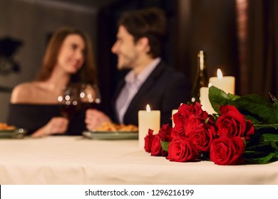 Loving Couple In A Restaurant Celebrating Valentine Day. Romantic Dinner For Couple, Booking Concept