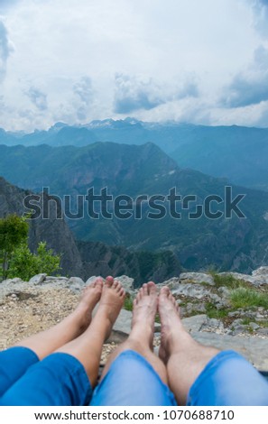 Loving couple resting on the top of the mountain after climbing