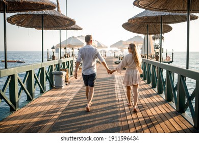 A loving couple is resting at the sea in Turkey. Man and woman on the pier. Sea tour. Honeymoon. Couple on a honeymoon trip. A beautiful couple travels the world. Happy couple on vacation.