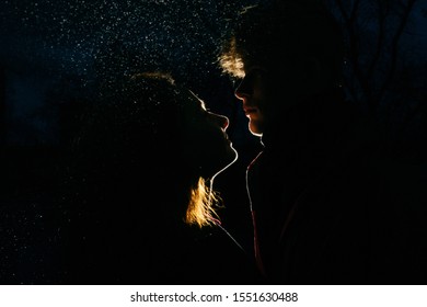 Loving Couple Silhouette In Dark. Back Light And Spray. Beautiful Effect.