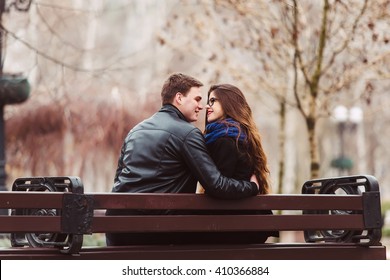 Loving Couple Sitting On A Bench