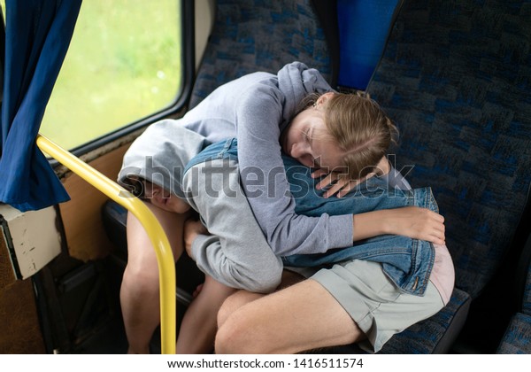 Loving couple\
sleeping and hugging in\
bus.